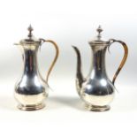 George V Eastern style silver coffee pot with matching hot water jug, the handles with woven cane,