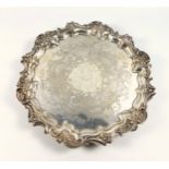 George V silver salver with a scrolling foliate rim and engraved scrolling foliate design by