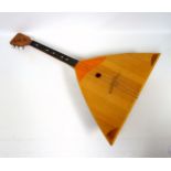 Balalaika, 2 Japanese Aulos plastic flutes, 6 other instruments, metronome, and an etching by Ray