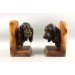 Two alabaster bookends, each mounted with a spaniel's head, H.20cm. (2)