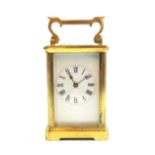 Brass Carriage timepiece with white enamel Roman Numeric Dial and 5 glass case with scroll handle