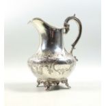 Victorian silver milk jug with embossed scrolling decoration, two vacant cartouches and gilt