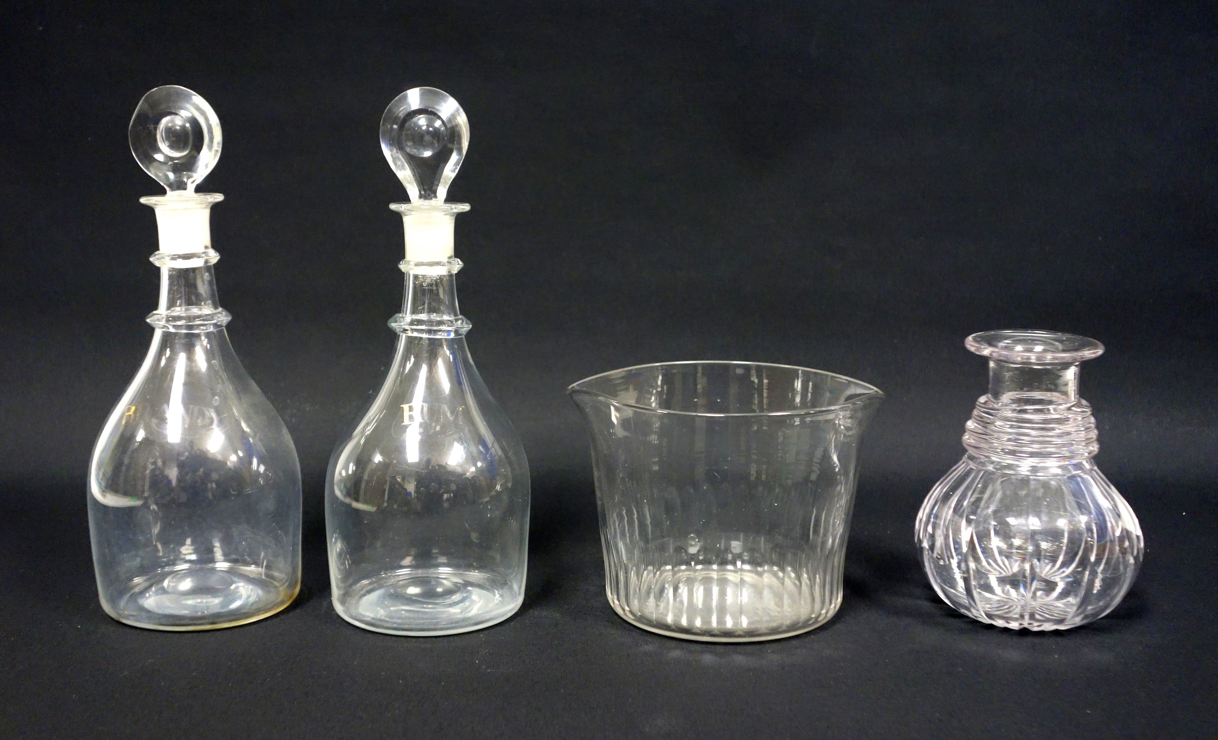 Pair of Georgian glass "Prussian" decanters, faintly lettered "Brandy" and "Rum", with associated