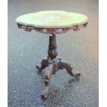 Italian carved walnut table with a shaped oval top inlaid with 2 deer on a thuya ground, within a
