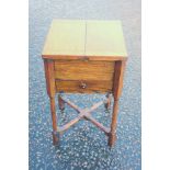 George V oak work table with a double hinged rising top and drawer, on turned legs joined by crass