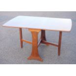 G Plan teak finish drop-leaf dining table, 136 x 91cm overall, and 4 teak rail-back chairs. (5)