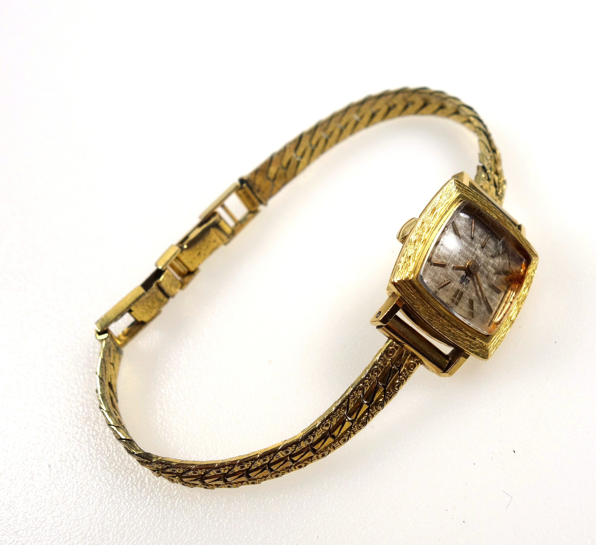 French ladies yellow metal wristwatch with a square dial and bark effect bezel, on a gilt metal