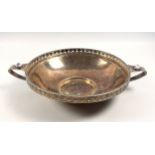 Arts and Crafts silver twin handled hammered footed bowl with set cabochons to handles and pierced