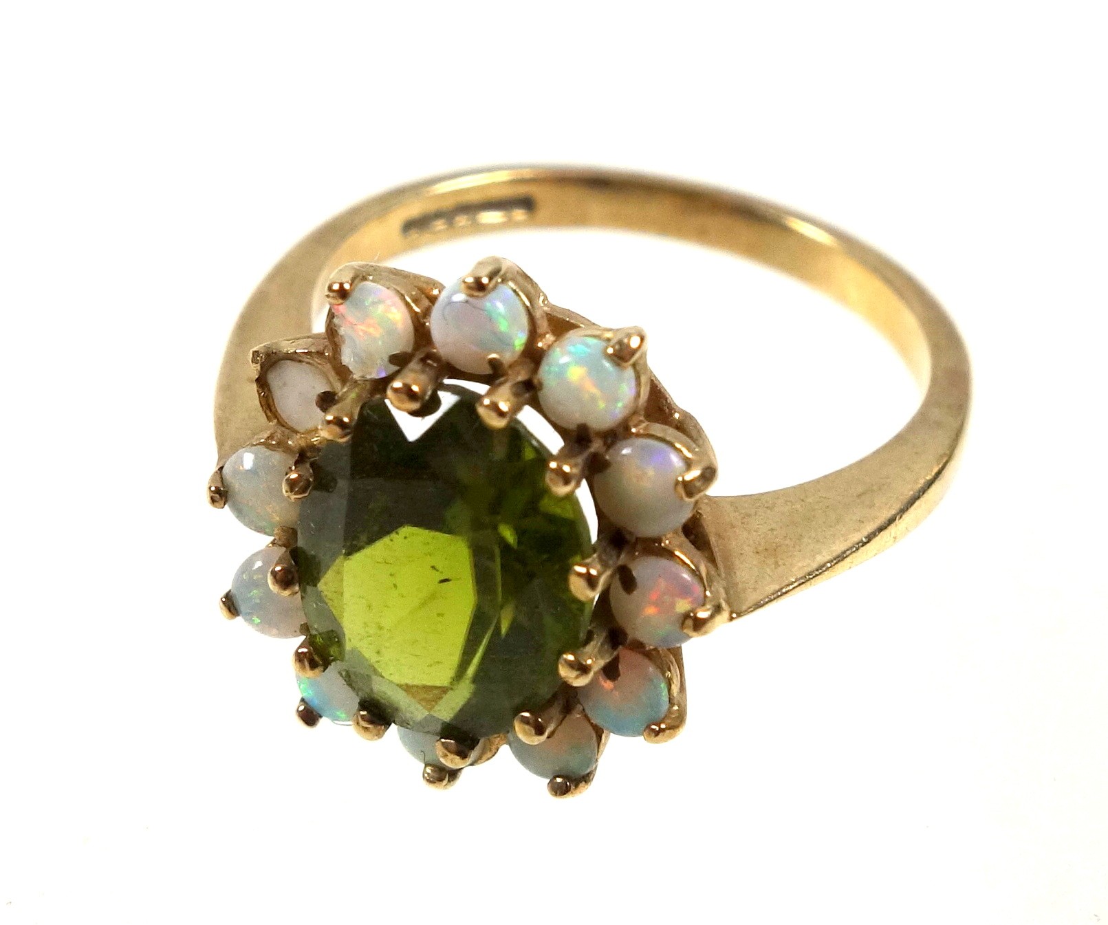 9ct gold ring set oval cut peridot within a band of 12 opals, size P, gross 3.4grs