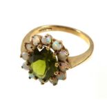 9ct gold ring set oval cut peridot within a band of 12 opals, size P, gross 3.4grs