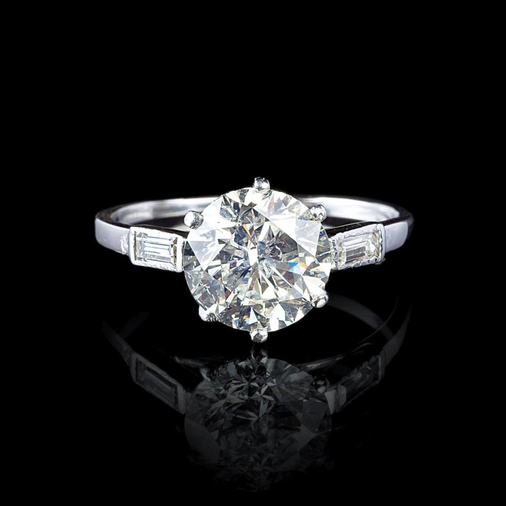 A Solitaire Diamond Ring with Diamond Baguettes.