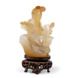 A CHINESE AGATE FIGURE OF A MAIDEN, QING DYNASTY, 19TH CENTURY