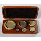 A CASED SET OF BRASS WEIGHTS, DE GRAVE AND CO
