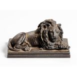 A CAST-IRON FIGURE OF A RECUMBENT LION