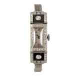 A DIAMOND AND ONYX-SET PLATINUM COCKTAIL WRISTWATCH