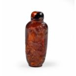 A CHINESE AMBER 'PEACH, LOTUS AND BAT' SNUFF BOTTLE, QING DYNASTY, 19TH CENTURY