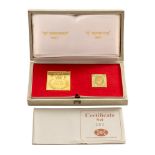 A CASED SET OF TWO 18CT GOLD EARLY NATAL POSTAGE STAMP REPLICAS