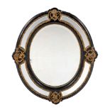 AN EBONISED AND GILT-METAL MOUNTED MIRROR