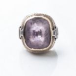 A BISHOP'S RING Bezel-set to the top with a cushion-cut amethyst weighing approximately 40 carats,