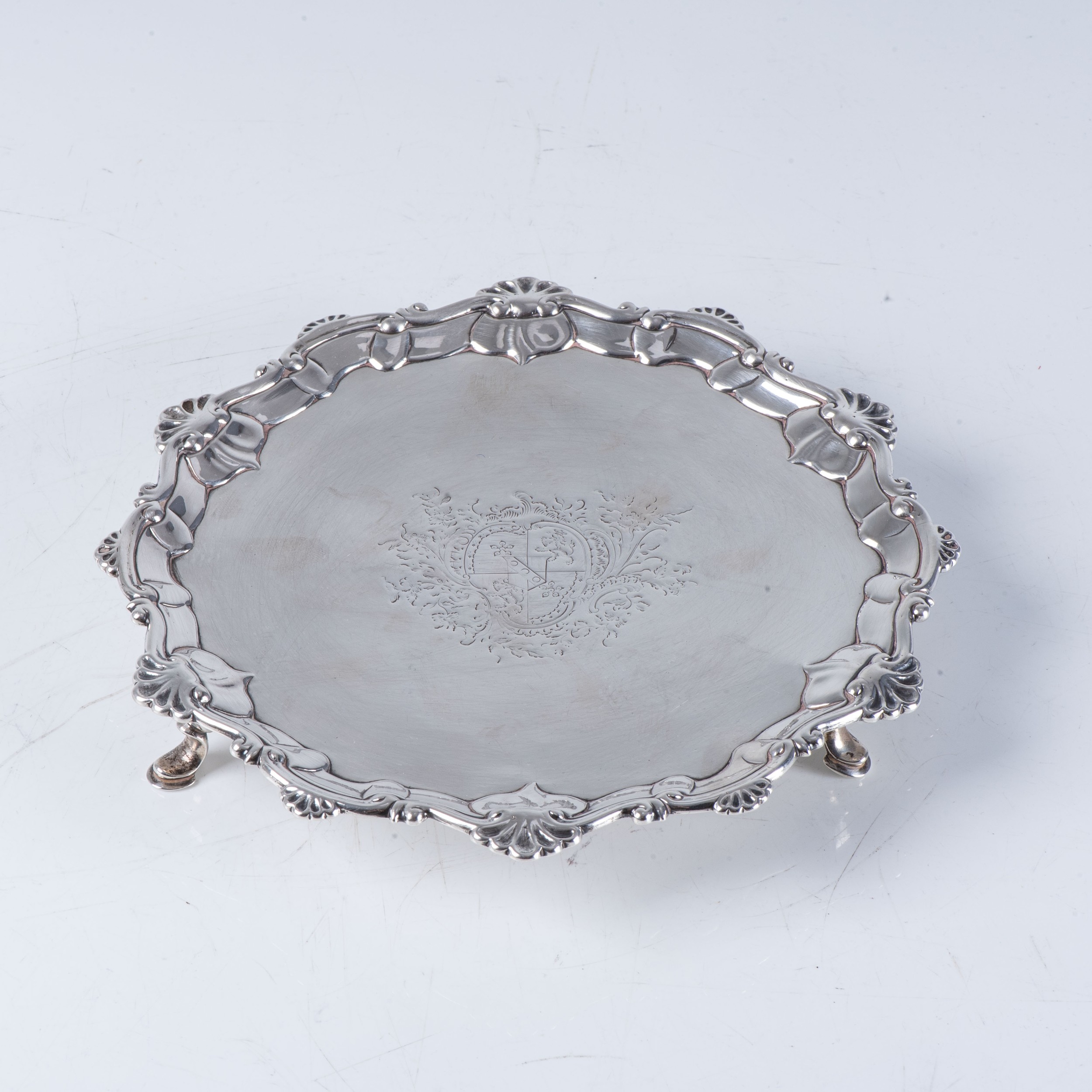 GEORGE III CIRCULAR SILVER WAITER Thomas Hannam & John Crouch, with shaped shell and scroll rim,