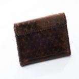 A GENTLEMAN'S LEATHER WALLET cross over design, circa 1930 17 by 13cm