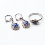 A SAPPHIRE RING AND PAIR OF EARRINGS The ring claw-set to the center with a natural sapphire flanked