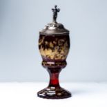 A BOHEMIAN RUBY GLASS GOBLET WITH SILVER COVER, CIRCA 1850 The faceted ovoid bowl enamelled and gilt