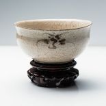 AN ORIENTAL CREAM GLAZE BOWL The bell-shaped bowl with deep rounded sides rising from a short
