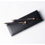 A CROSS PEN AND PENCIL SET Black and gold-plated, accompanied by an original box