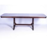 A MAHOGANY EXTENDING DINING TABLE, 20TH CENTURY The rectangular top with corners above a pair of