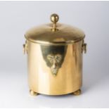 A BRASS JAR AND COVER Applied to the fore with an abstract floral motif, opposing ring handles,