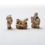 A JAPANESE IVORY 'FUKUROKUJU' NETSUKE The seated deity beside a scholar reading from a book;