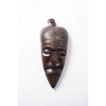 AN AFRICAN WOODEN MASK 68cm high, 20cm wide