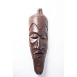 AN AFRICAN WOODEN MASK 70cm high, 28cm wide