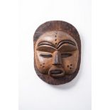 AN AFRICAN WOODEN MASK