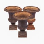 A SET OF THREE CAST IRON GARDEN PLANTERS 62cm high, 48,5cm diameter