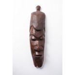 AN AFRICAN WOODEN MASK 72cm high, 25cm wide