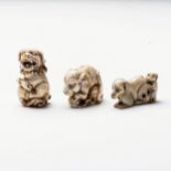 A JAPANESE IVORY 'TIGRESS AND CUB' NETSUKE Carved as a tigress tending her cub; together with a