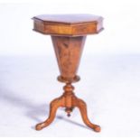 A VICTORIAN WALNUT WORK TABLE The octagonal hinged top enclosing a fabric lined compartmentalized