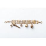 A GOLD CHARM BRACELET An open panel work design, with 5 charms, in 9ct yellow gold, 15cm in length
