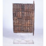 A DOGON STYLE GRANARY DOOR The door carved with figures of women  105cm high including perspex