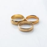 A COLLECTION OF GOLD BANDS Different shapes and sizes, assorted carats  (3)