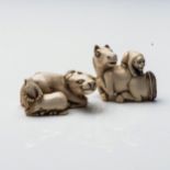 A JAPANESE IVORY 'WATER BUFFALO GROUP' NETSUKE The recumbent water buffalo together with her calf;