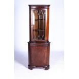 A MAHOGANY STANDING CORNER CUPBOARD, 20TH CENTURY The bowfront top fitted with a paneled glass