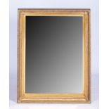 A RECTANGULAR GILTWOOD WALL MIRROR, MODERN The frame carved with leafage and vertical and horizontal