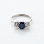 A SAPPHIRE AND DIAMOND RING Claw-set to the center with a round brilliant-cut sapphire weighing