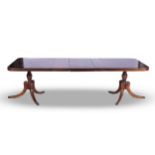 A LATE VICTORIAN REGENCY-STYLE MAHOGANY EXTENDING DINING TABLE The rectangular top with rounded