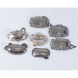 MISCELLANEOUS GROUP OF SEVEN DECANTER LABELS  Comprising 4 silver, engraved for Sherry, Brandy,