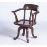 A STAINED OAK CAPTAIN'S CHAIR, EARLY 20TH CENTURY With curved top rail above three vertical splat,