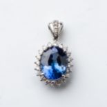 A SAPPHIRE AND DIAMOND PENDANT Claw-set to the center with an oval certified sapphire weighing 7,